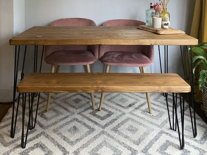 Rustic industrial dining table made from redwood pine with black steel hairpin legs, perfect for a mid-century modern kitchen or dining room