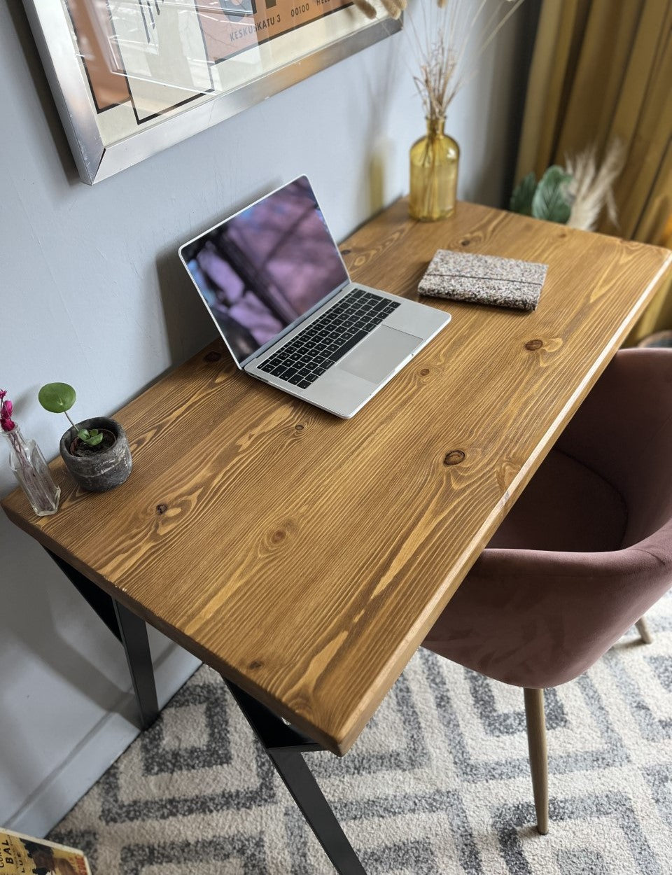 Industrial redwood pine desk with black steel legs, ideal for a mid-century modern home office setup.