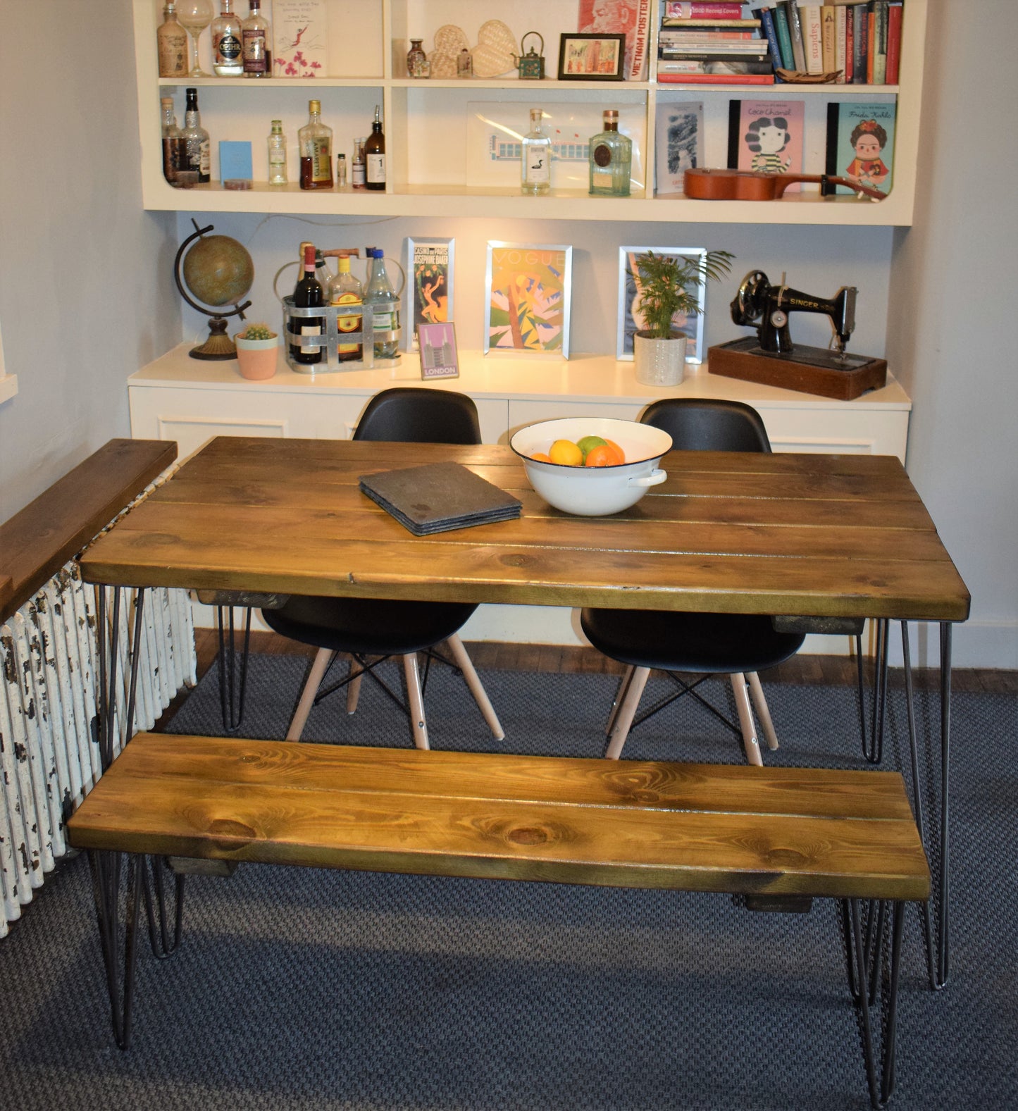 Rustic industrial dining table crafted from reclaimed pine with raw steel hairpin legs, ideal for mid-century modern kitchens and dining spaces