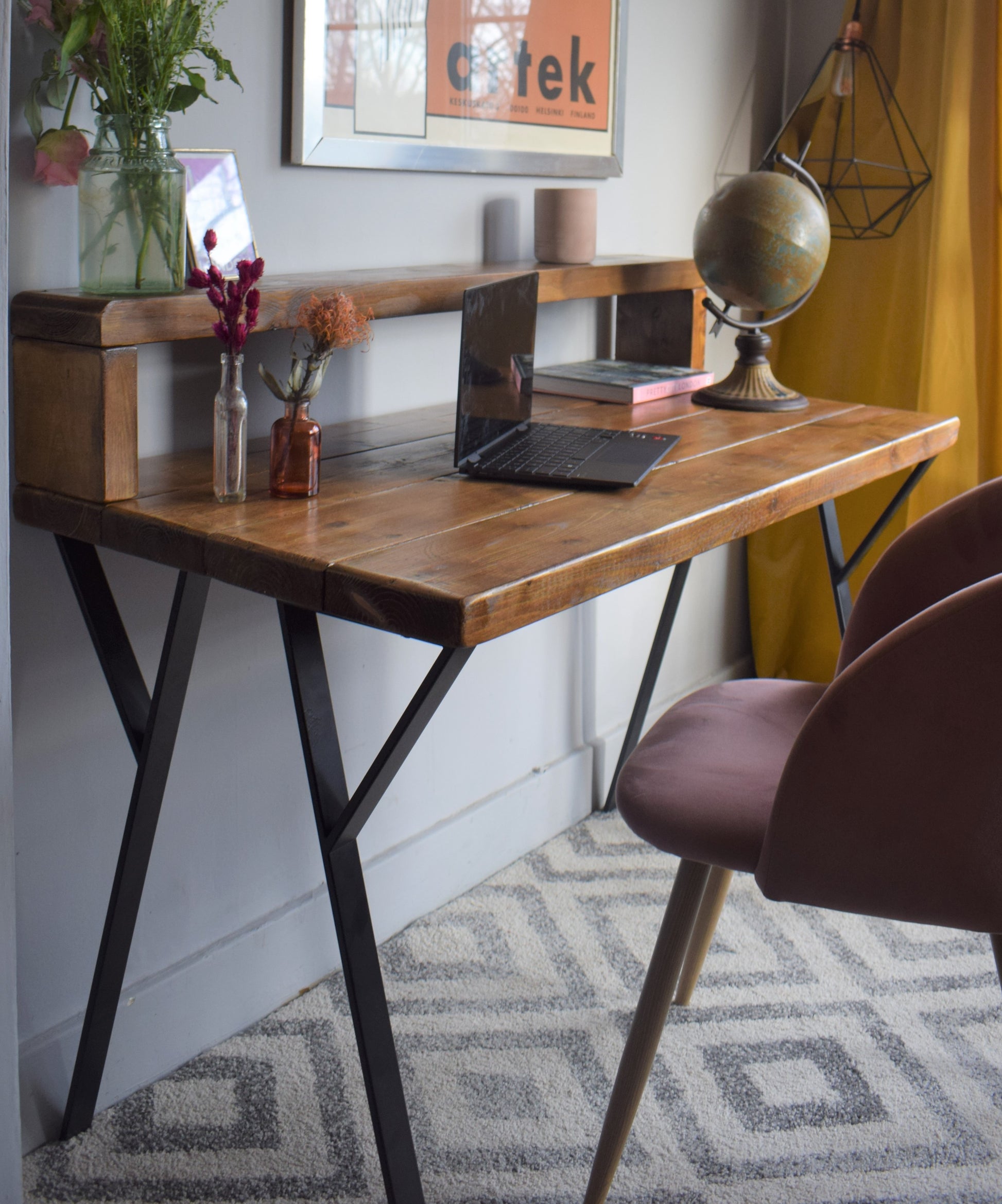 Industrial redwood pine desk with black steel legs, featuring a mid-century modern design and a riser shelf for home office use