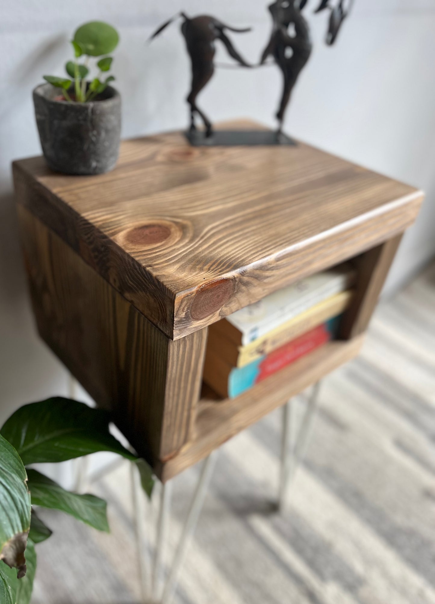 Stylish redwood pine bedside table with white steel hairpin legs, ideal for a mid-century modern bedroom