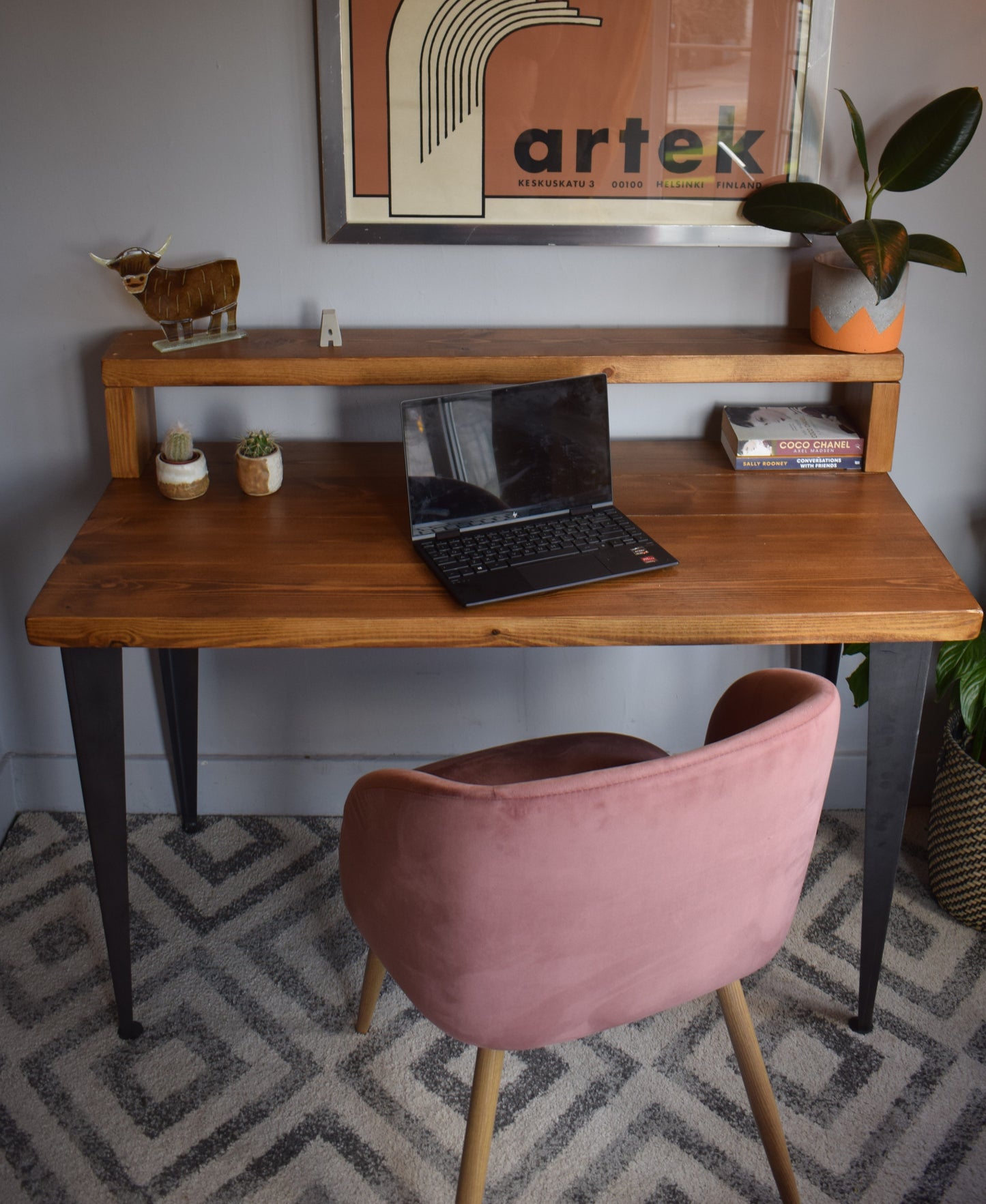 Side view of industrial pine desk with riser shelf