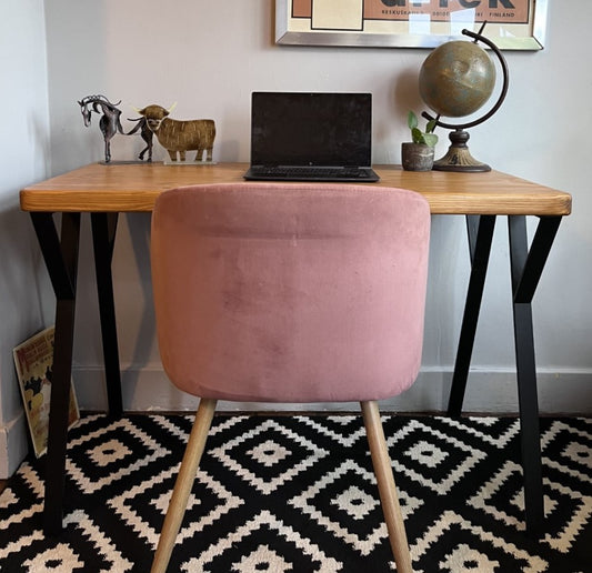 Industrial redwood pine desk with black steel legs, ideal for a mid-century modern home office space