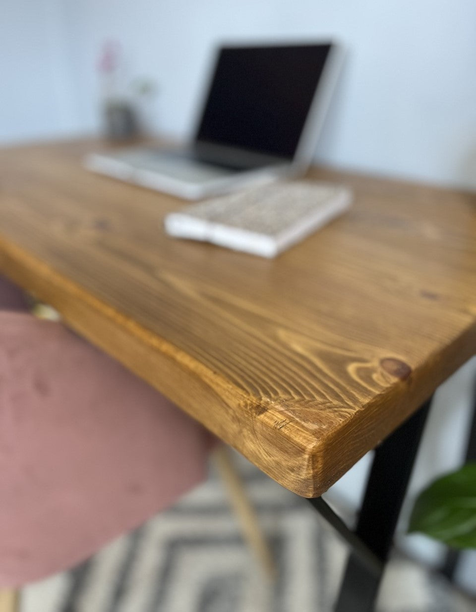 Industrial redwood pine desk with black steel legs, ideal for a mid-century modern home office setup.