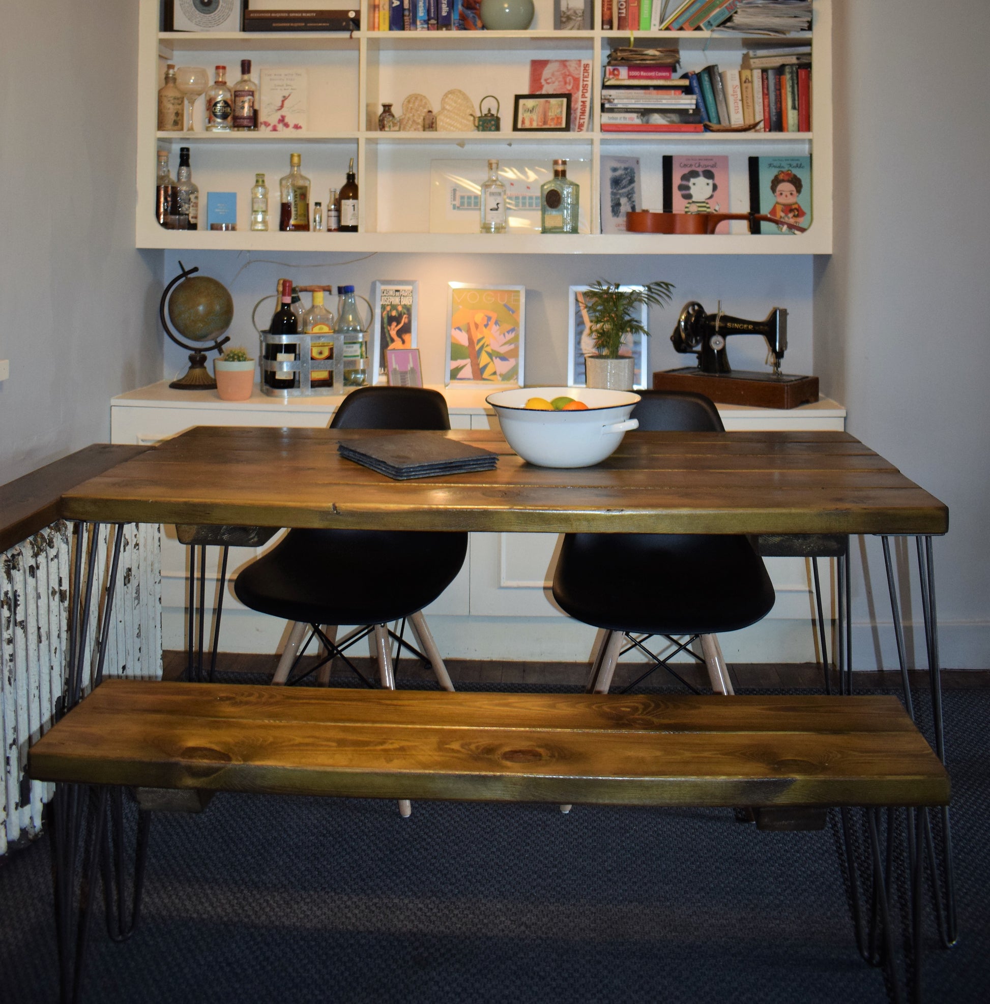 Rustic industrial dining table crafted from reclaimed pine with raw steel hairpin legs, ideal for mid-century modern kitchens and dining spaces