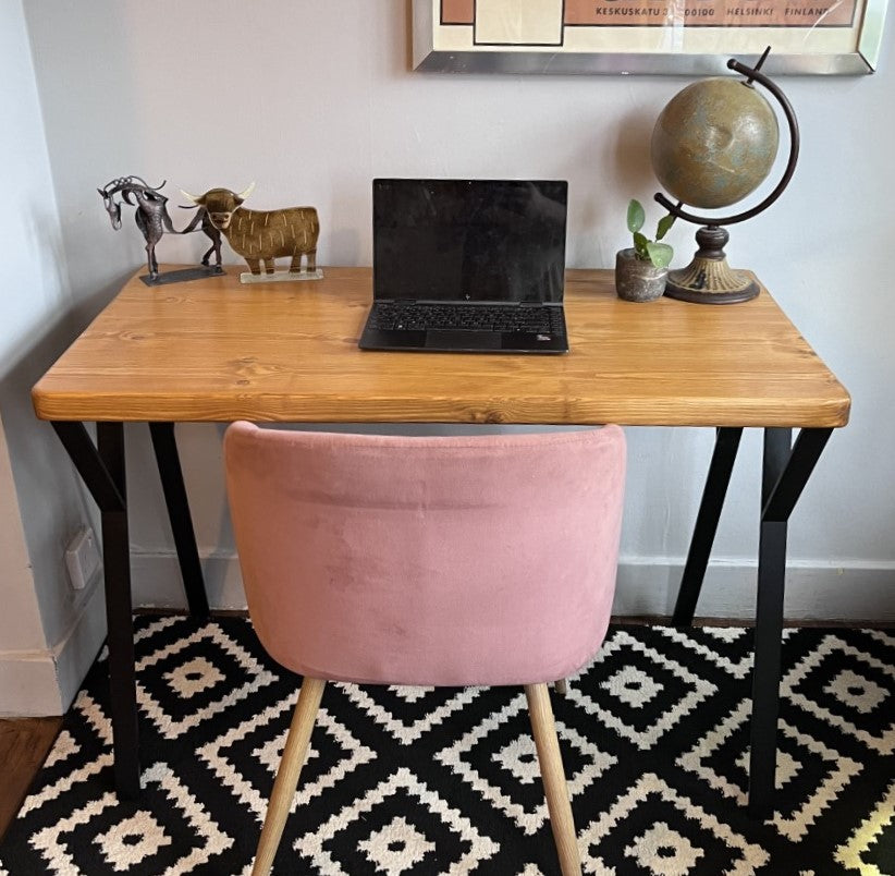 Industrial redwood pine desk with black steel legs, ideal for a mid-century modern home office space