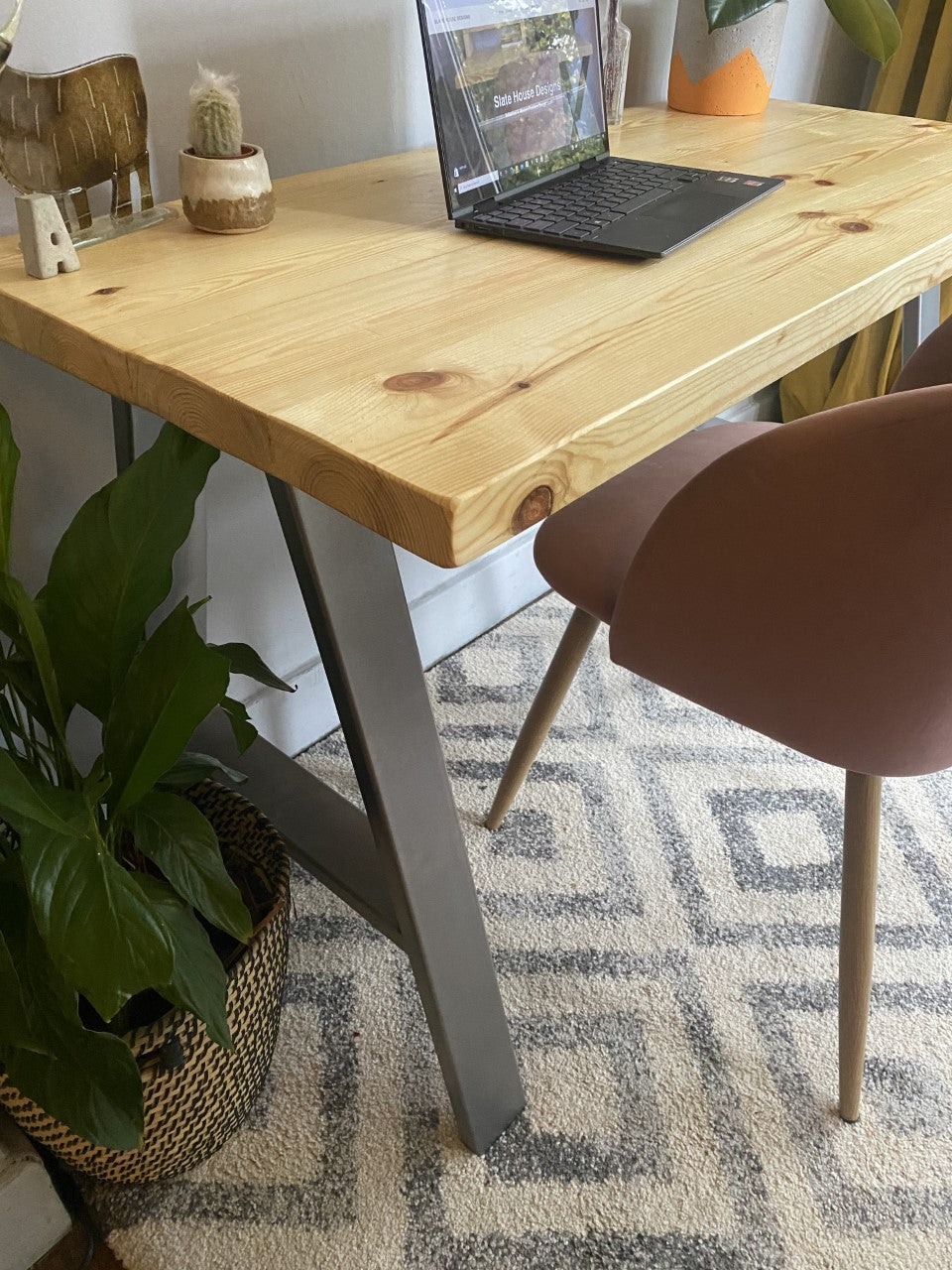 Industrial-style redwood pine desk with steel A-frame legs, perfect for a sleek, modern home office