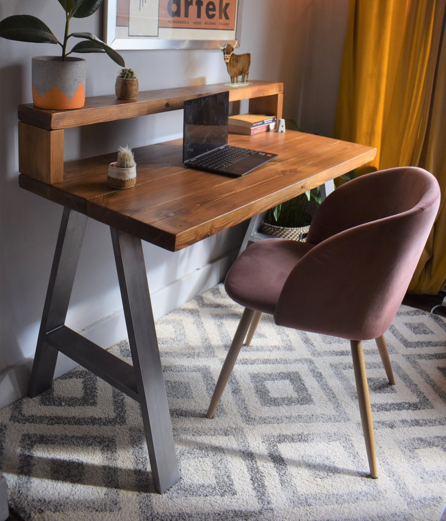 Industrial redwood pine desk with steel A-frame legs and shelf, combining modern design with practical storage for home offices