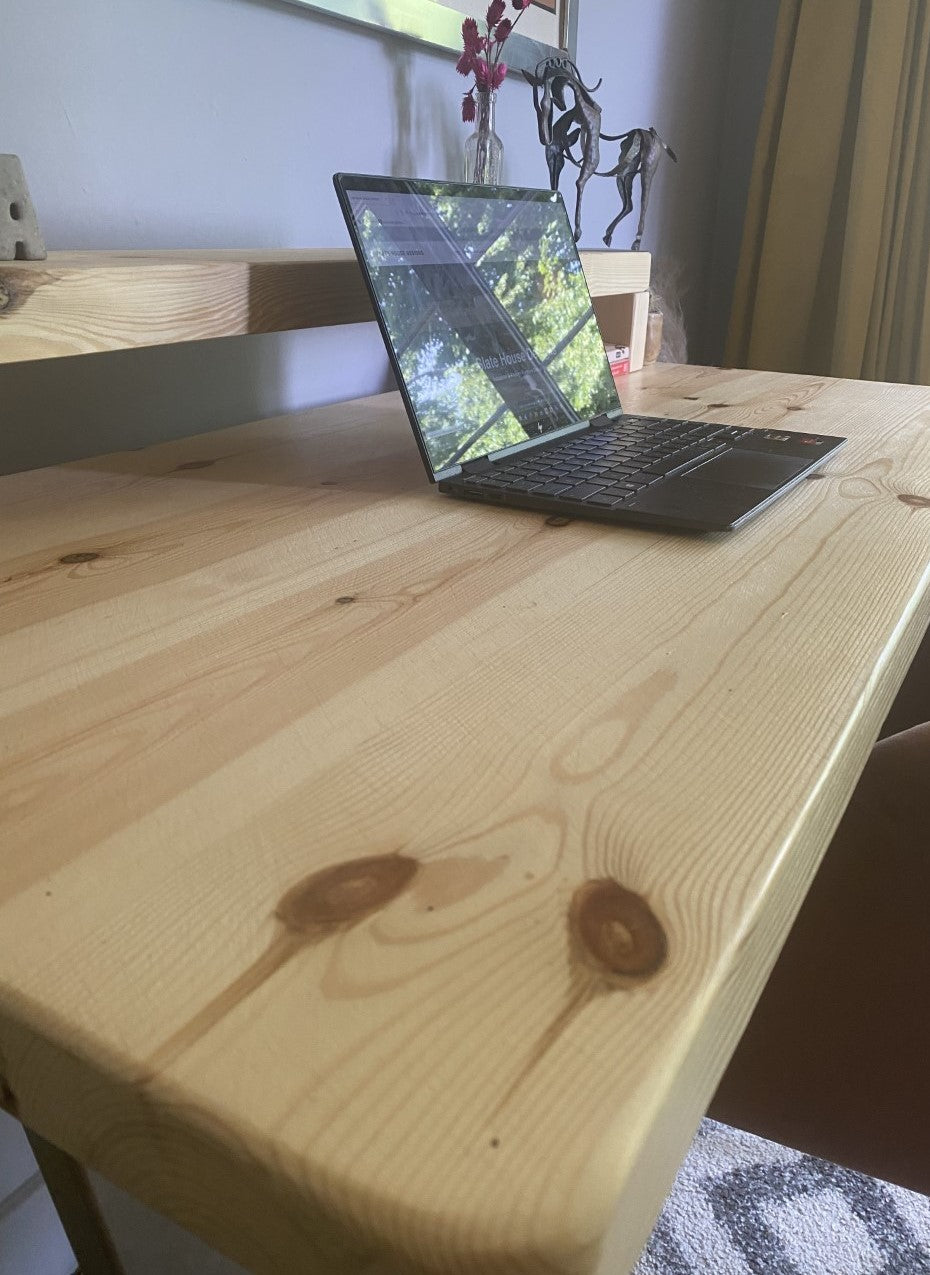 Redwood pine desk with steel A-frame legs and a mid shelf, combining industrial style with practical storage for home offices