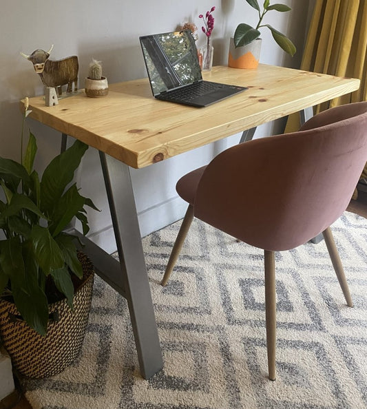 Industrial-style redwood pine desk with steel A-frame legs, perfect for a sleek, modern home office