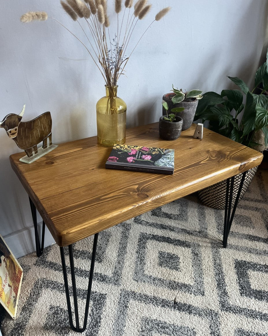 Rustic pine coffee table with sleek black steel hairpin legs, perfect for enhancing the modern and mid-century charm of your living room