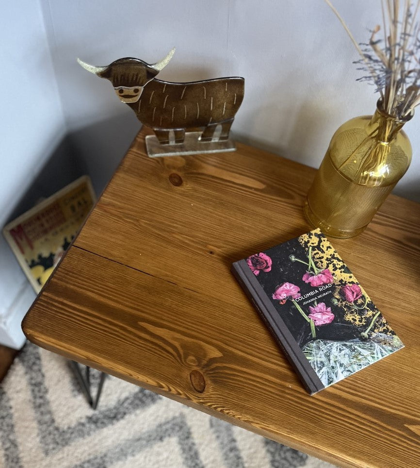 Rustic pine coffee table with sleek black steel hairpin legs, perfect for enhancing the modern and mid-century charm of your living room