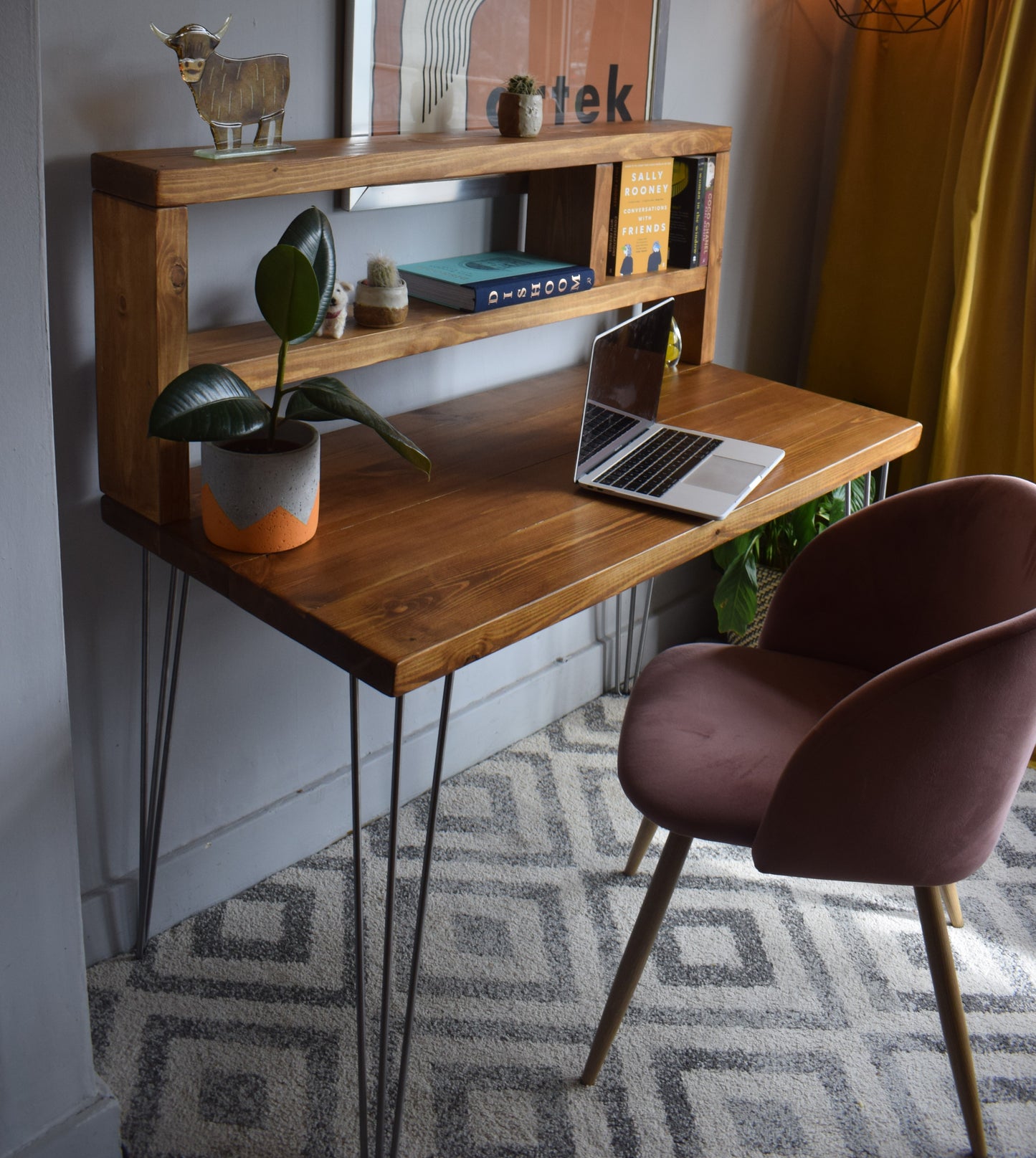 Side view of industrial redwood pine desk with raw steel legs and tall shelf storage.