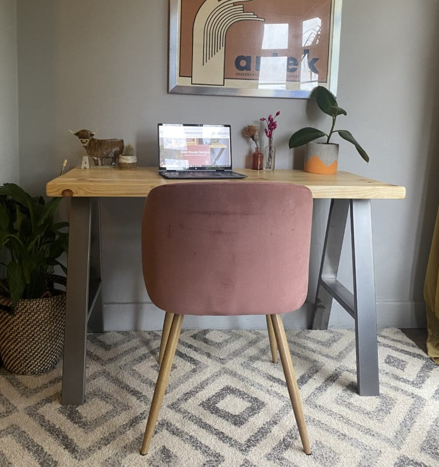 Industrial-style redwood pine desk with steel A-frame legs, perfect for a sleek, modern home office