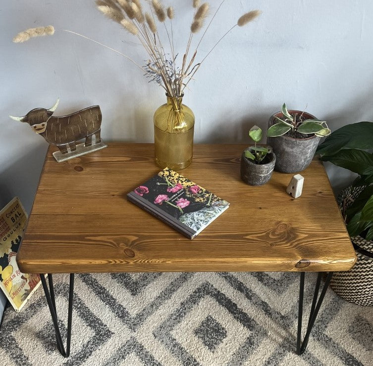 Rustic pine coffee table with sleek black steel hairpin legs, perfect for enhancing the modern and mid-century charm of your living room