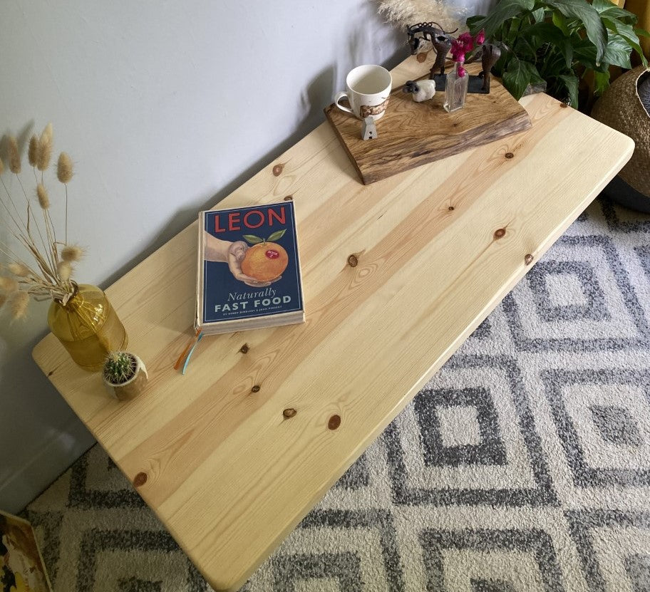 Stylish redwood pine coffee table with steel frame legs, designed to add a bold mid-century modern touch to your living room