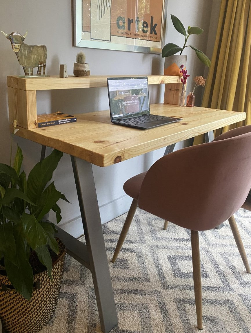 Industrial-style redwood pine desk with steel A-frame legs and a functional shelf, perfect for a modern home office.