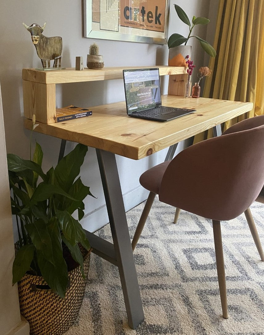 Industrial-style redwood pine desk with steel A-frame legs and a functional shelf, perfect for a modern home office.