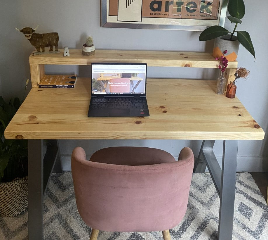 Industrial-style redwood pine desk with steel A-frame legs and a functional shelf, perfect for a modern home office.