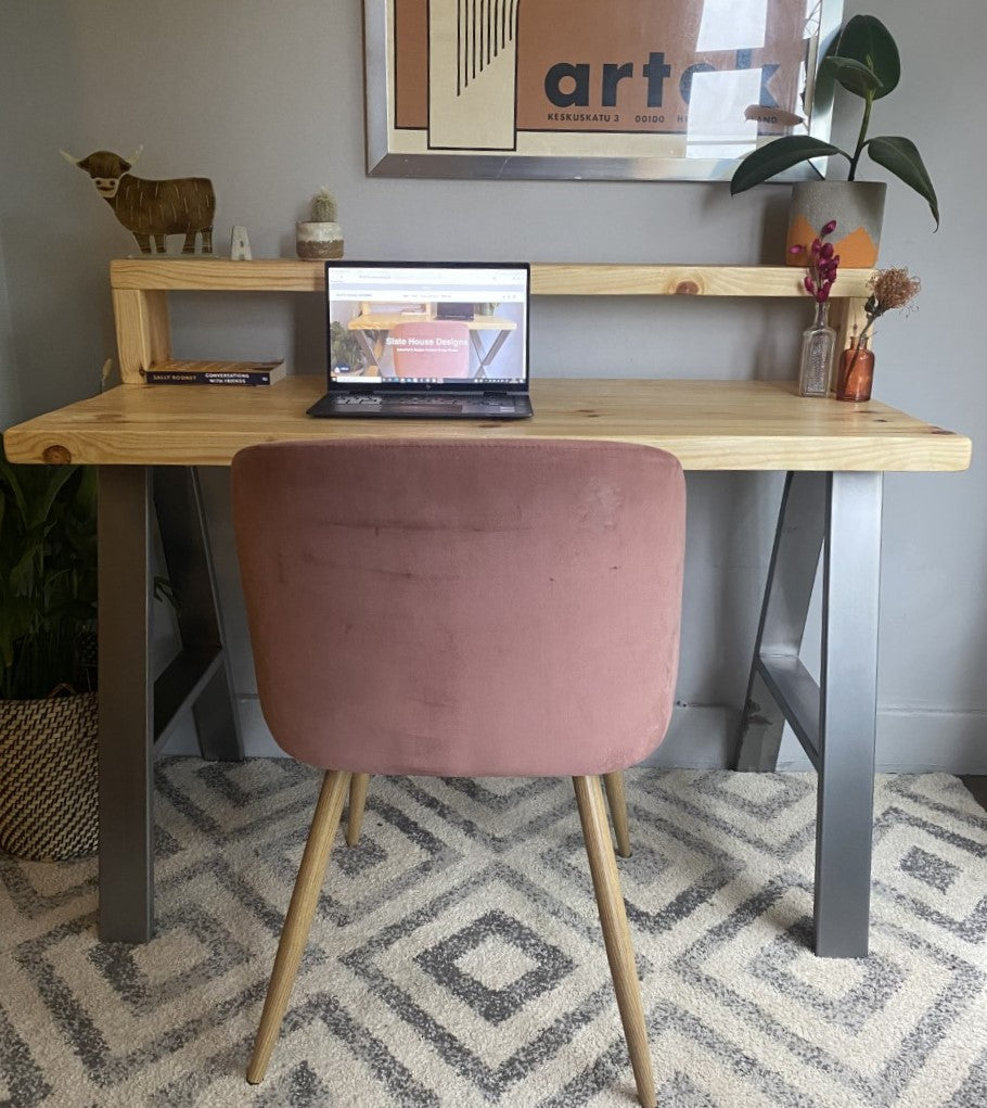 Industrial-style redwood pine desk with steel A-frame legs and a functional shelf, perfect for a modern home office.