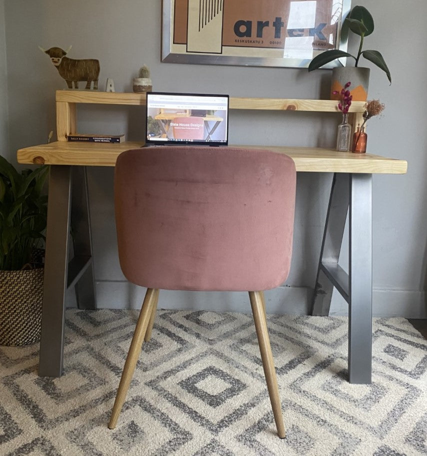 Industrial-style redwood pine desk with steel A-frame legs and a functional shelf, perfect for a modern home office.