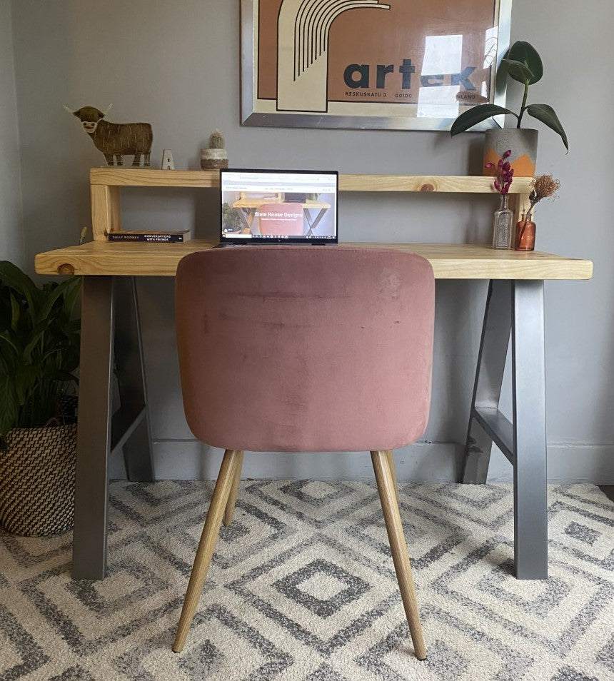 Industrial-style redwood pine desk with steel A-frame legs and a functional shelf, perfect for a modern home office.