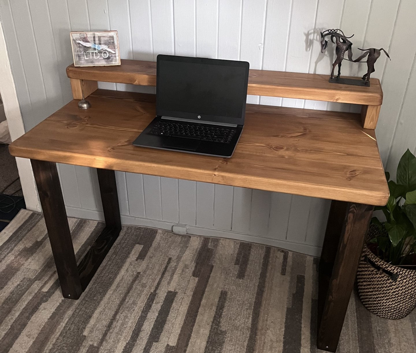 Industrial redwood pine desk with black wood frame legs and shelf for home office, mid-century modern style