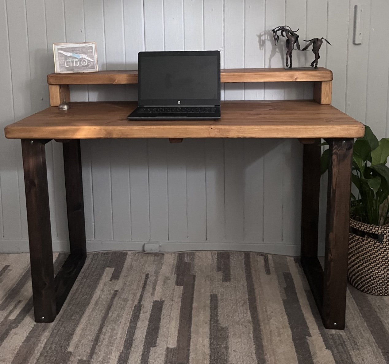 Industrial redwood pine desk with black wood frame legs and shelf for home office, mid-century modern style