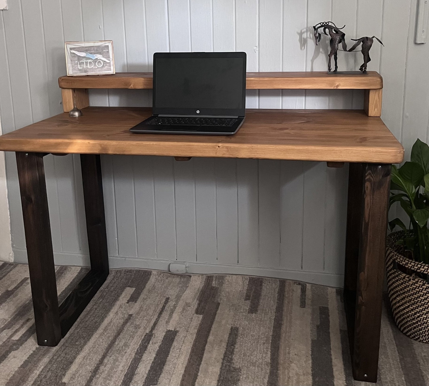 Industrial redwood pine desk with black wood frame legs and shelf for home office, mid-century modern style