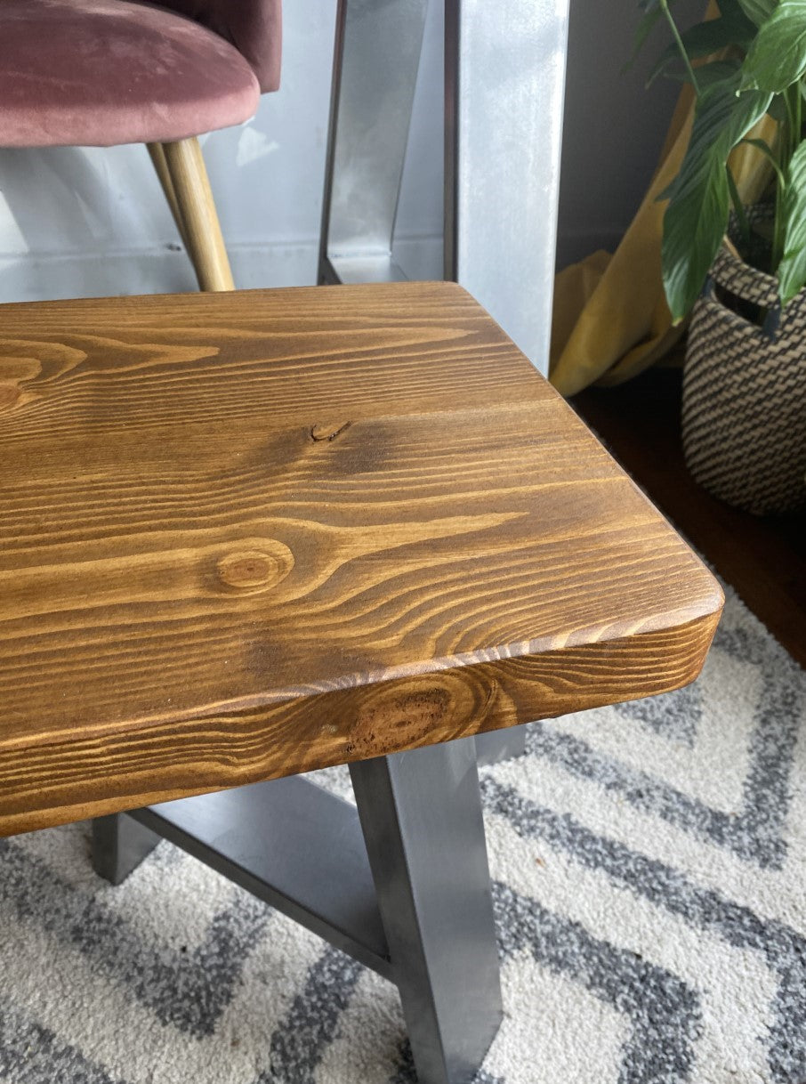 Rustic redwood pine dining table with industrial steel A-frame legs, designed for mid-century modern kitchens and dining rooms