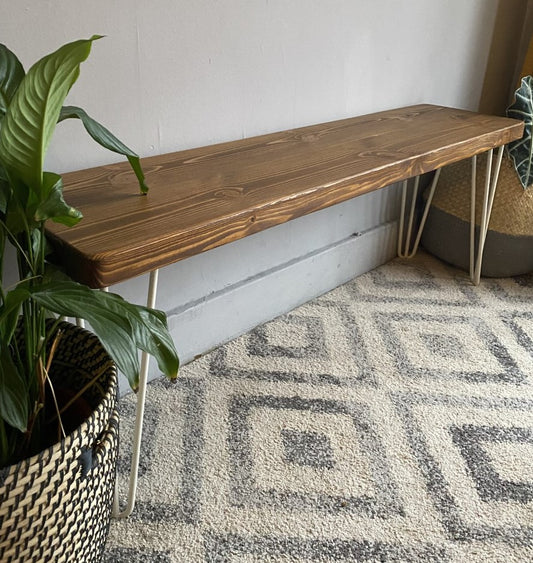 Industrial redwood pine bench with white steel hairpin legs, featuring a Scandinavian and mid-century modern style for home décor