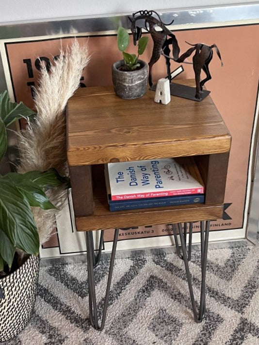 Elegant redwood pine bedside table with raw steel hairpin legs, perfect for a mid-century modern bedroom look