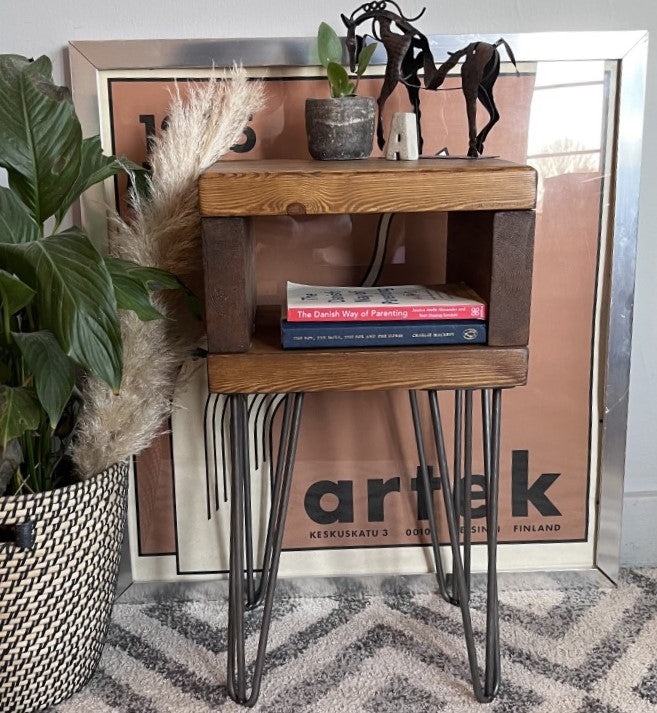 Elegant redwood pine bedside table with raw steel hairpin legs, perfect for a mid-century modern bedroom look