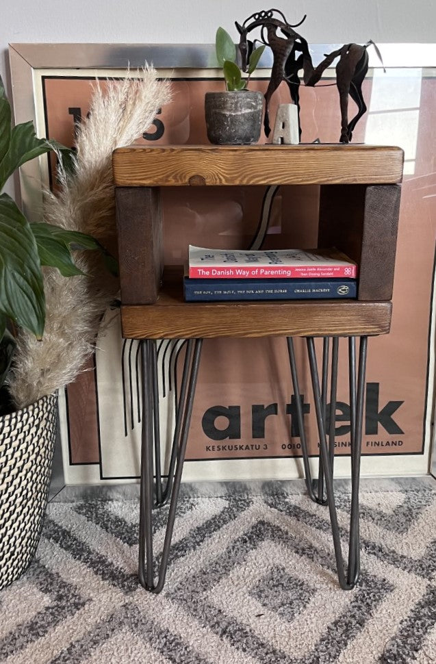 Elegant redwood pine bedside table with raw steel hairpin legs, perfect for a mid-century modern bedroom look