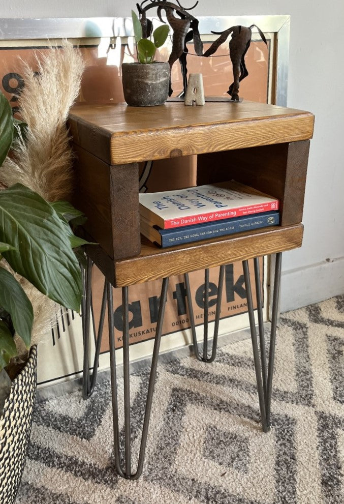 Elegant redwood pine bedside table with raw steel hairpin legs, perfect for a mid-century modern bedroom look