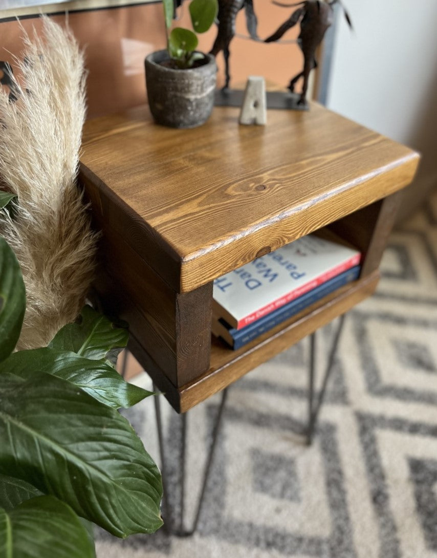 Elegant redwood pine bedside table with raw steel hairpin legs, perfect for a mid-century modern bedroom look