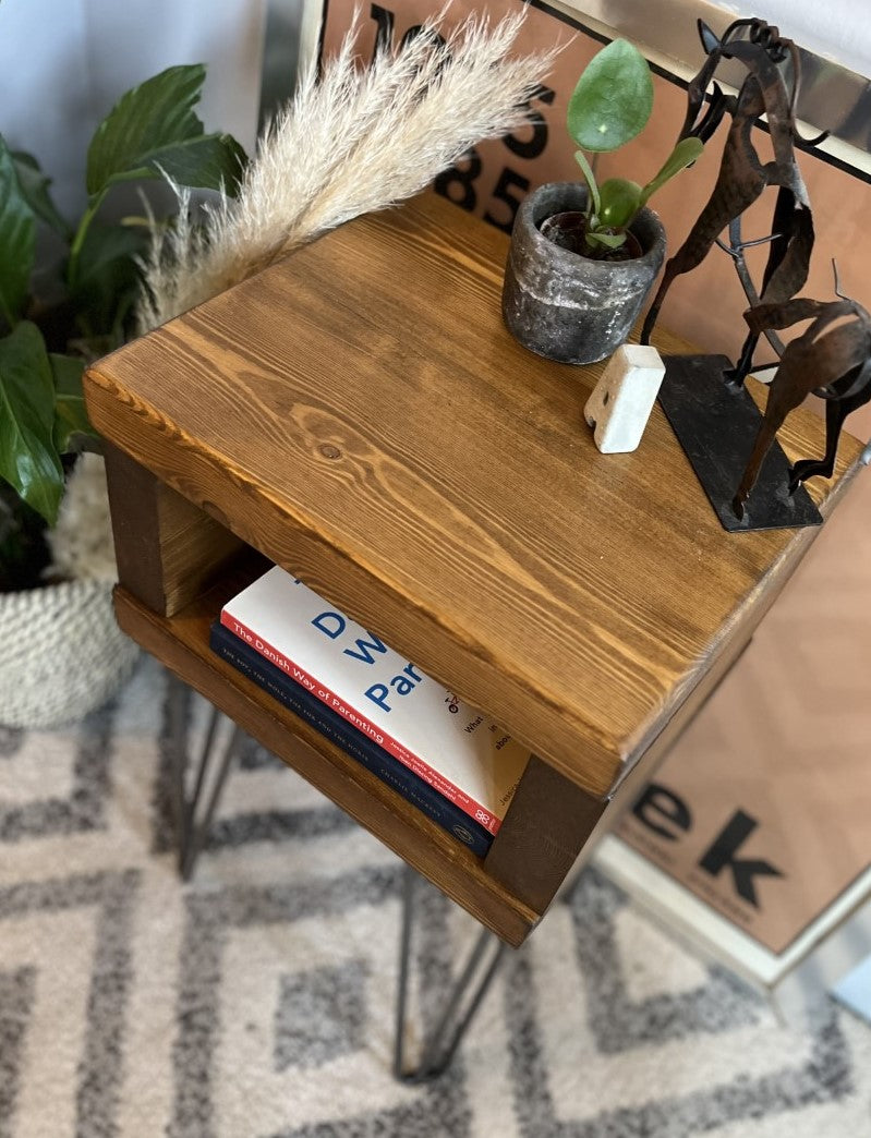 Elegant redwood pine bedside table with raw steel hairpin legs, perfect for a mid-century modern bedroom look